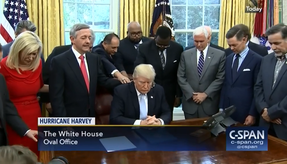 Pastor Robert Jeffress leading President Donald Trump and other evangelical advisors in prayer in the Oval Office.