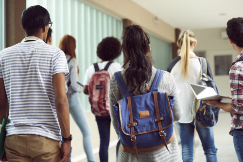 high school students walking in hallway