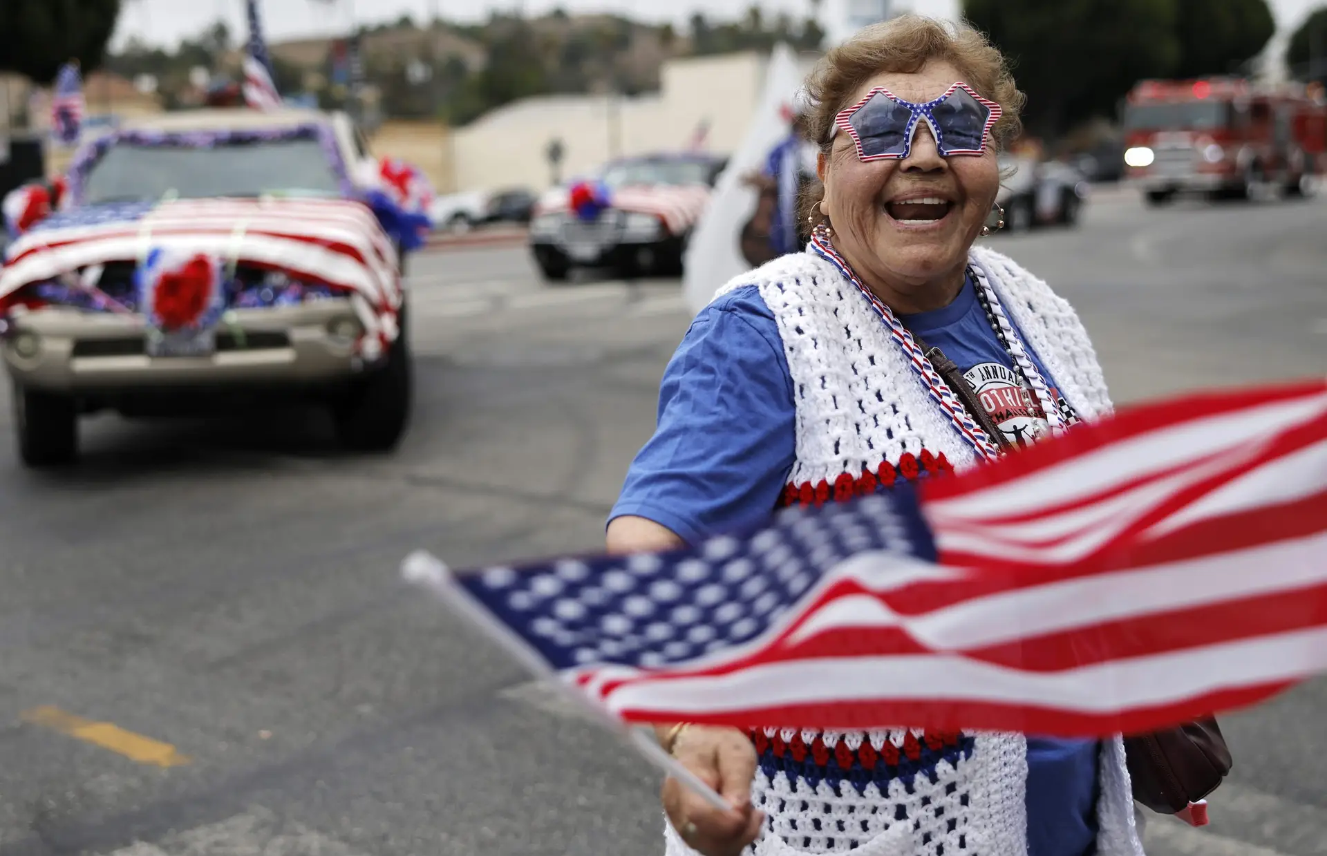 A participant waves an American flag during the 67th annual El Sereno Independence Day Parade in the predominantly Latino community of El Sereno on June 27, 2026, in Los Angeles, California. It was held as communities across the country are celebrating America's 250th anniversary. (Photo by Mario Tama/Getty Images)