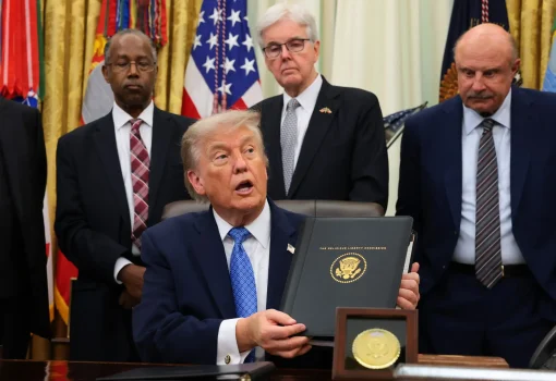 President Donald Trump displays the Religious Liberty Commission's draft report during an event in the Oval Office of the White House on June 26, 2026, in Washington, D.C. (Photo by Anna Moneymaker/Getty Images)